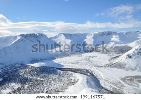 Majestic pan view of mountain rocky snow covered landscapes in Khibiny, Russian Federation