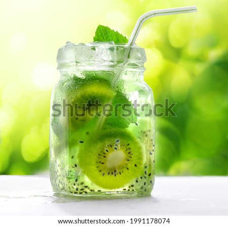 Kiwi cocktail drink with chia seeds in glass jar