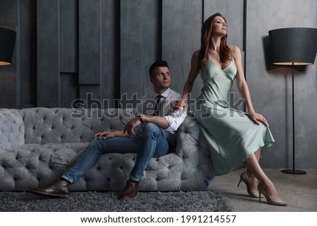 Beautiful couple in stylish living room. Luxury lifestyle Royalty-Free Stock Photo #1991214557