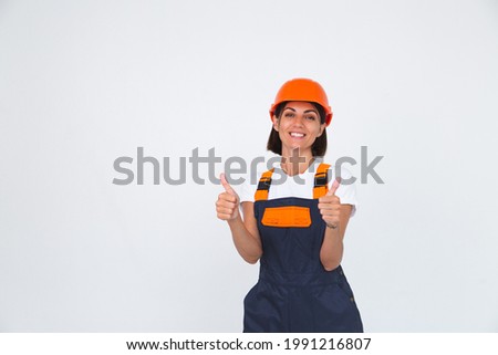 Pretty woman engineer in building protective helmet on white background confident smile show thumb up