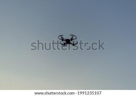 A silhouette of a drone in the motion