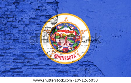 State of State of Minnesota flag is painted onto an old brick wall