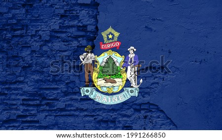 State of Maine flag is painted onto an old brick wall
