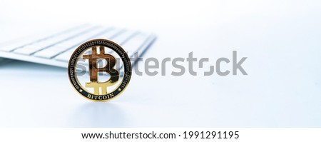 Bitcoin business. Gold Crypto currency BTC Bitcoin with keyboard on white background. Golden Bit Coin virtual cryptocurrency or blockchain technology. Virtual money and mining concept