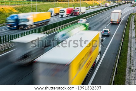 Trucks on six lane controlled-access highway in Poland.
 Royalty-Free Stock Photo #1991332397