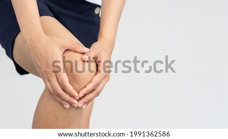 Women with knee pain, take the handle and white background: medical concepts
