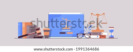 law and justice concept gavel judge books and scales on laptop screen online lawyer legal advice Royalty-Free Stock Photo #1991364686