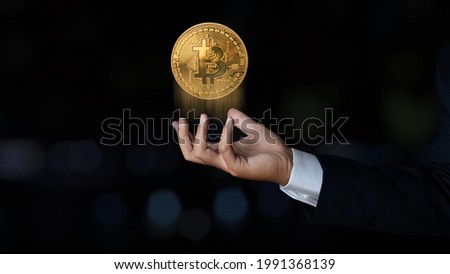 Businessman showing bitcoin virtual money. Bitcoin cryptocurrency concept. Digitall symbol of a new virtual currency