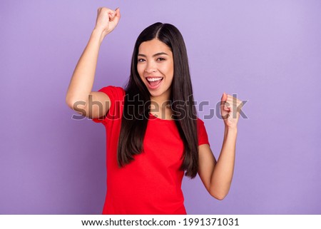 Photo of yell cool young lady hands fists open mouth wear red t-shirt isolated on violet color background