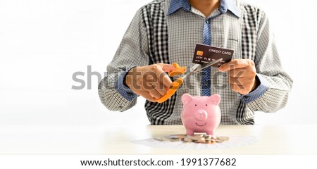 Man using scissors to cut credit card. Concept money, saving, Financial stability, Stop luxury, Create investment opportunity, Start a new business, Bankruptcy protection. Selective focus, copy space Royalty-Free Stock Photo #1991377682