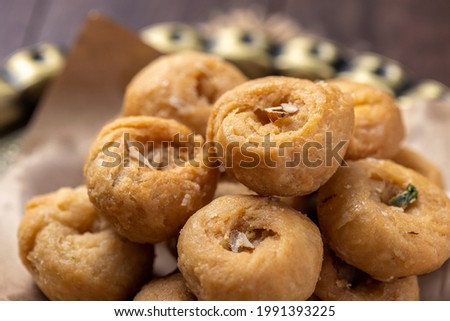 Indian traditional sweet balushahi served on a metal plate on wooden background Royalty-Free Stock Photo #1991393225