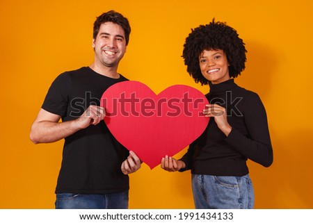 valentine couple holding a paper heart. valentine's day concept