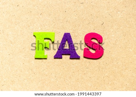 Color cloth alphabet letter in word FAS (Abbreviation of Fetal alcohol syndrome, Free alongside or Financial accounting standards) on wood background