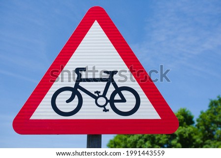UK Warning symbol in a red triangle. Bicycle traffic sign.Cycle route ahead.