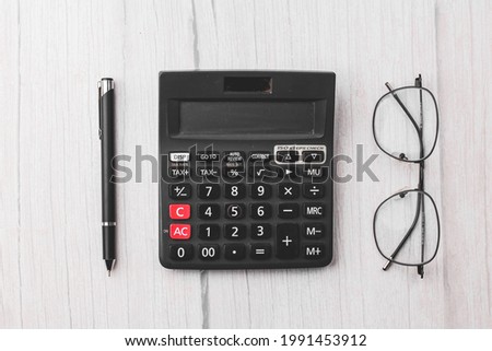 Black calculator on white texture background stock image.