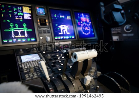 A typical dashboard panel in the cockpit of a private jet plane aircraft. Throttle control lever in focus. Royalty-Free Stock Photo #1991462495
