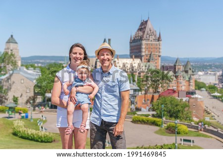 A nice Couple with baby in front of Chateau Frontenac at Quebec city in summer season