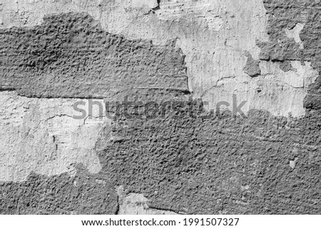 Grey concrete wall with natural defects. Fragment of the cement surface with natural texture. Monochrome palette of shades.