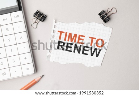Business concept. Notebook with text Time to renew sheet of white paper for notes, calculator, glasses, pencil, pen, in the white background