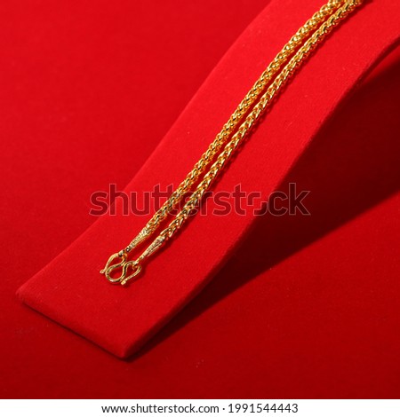 Gold necklace close up and luxury red background