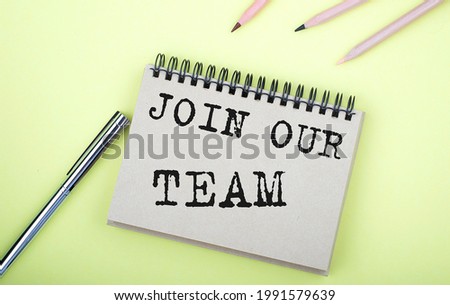 JOIN OUR TEAM text written on notebook with pencils