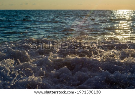 Summer sea sunset, the sun, waves and clouds, beautiful dramatic lighting
