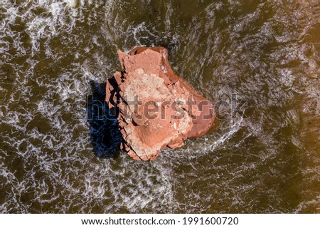 lone sandstone rock in the ocean