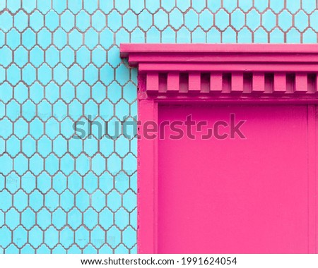 Turquoise blue tile wall with a hot magenta pink door entryway in Chinatown San Francisco, California