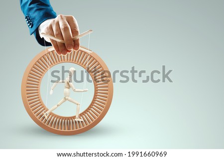 Male hand, puppeteer controls the puppet puppet with strings. The concept of shadow government, world conspiracy, manipulation, control Royalty-Free Stock Photo #1991660969