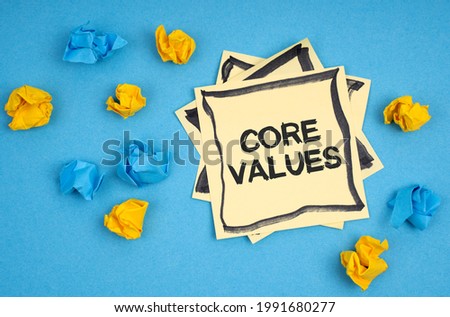 Business concept. On a blue background, there are pieces of paper and a sticker with the inscription - CORE VALUES