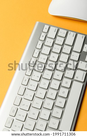 Keyboard and mouse isolated on yellow background