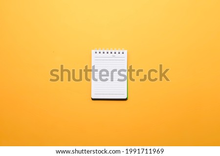 notepad isolated on yellow background