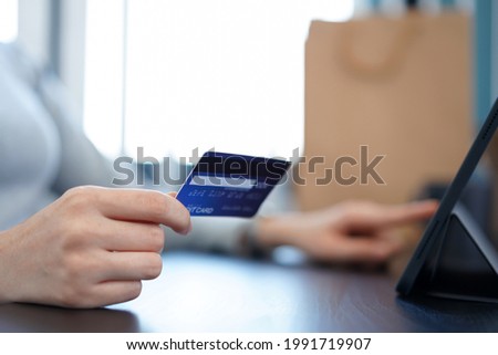 Shopping online concept a young woman using her credit card to facilitate   an online purchasing in online shopping application.
