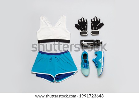 Sportwear fashion outfit flatlay still life isolated shot from above on grey background Royalty-Free Stock Photo #1991723648