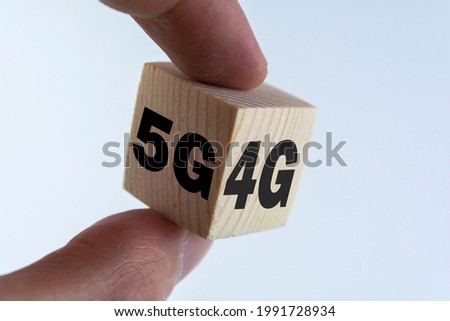Hand flipping wooden cube for change 4G to 5G. Technology change transformation to high speed and internet of thing.