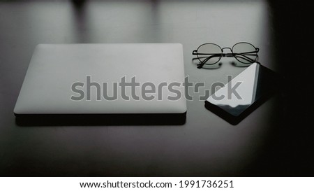 Empty tablet with smartphone and glasses on desk. Business and finance concept. Workplace, Flat lay with blank copy space.