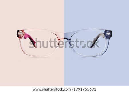 pink and blue transparent plastic color eye glasses isolated on background, ideal photo template for display or advertising sign or for a web banner