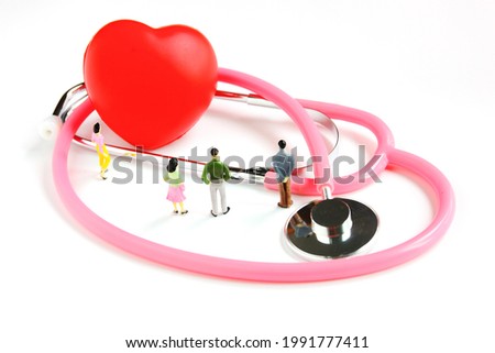 the figure people model woman man looking red heart on stethoscope isolate on white