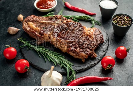 grilled cowboy beef steak on stone background