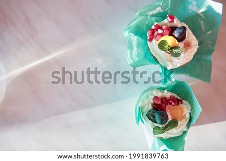Wrapped fruit and mint cakes, an alternative to birthday cake. Sugar free. Top view. Copy space with natural shadows. Happy birthday concept or Happy holidays.