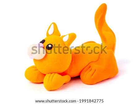 Orange cat from air plasticine isolated on white background. Children's creativity