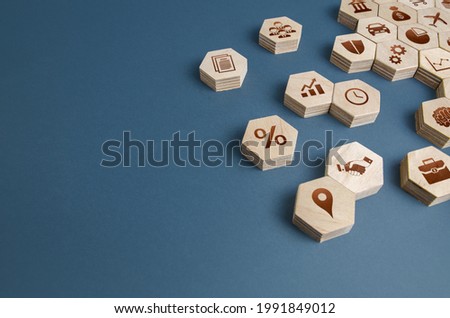 Wooden figurines with business attributes. Components for building a successful company and career growth. Management. Improving the investment climate, attracting investors. Business education. Royalty-Free Stock Photo #1991849012