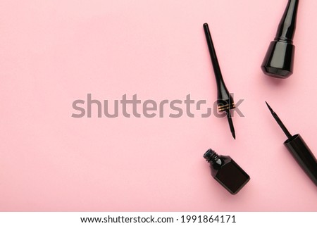 Eyeliners on pink background with copy space. Top view. Beauty concept Royalty-Free Stock Photo #1991864171