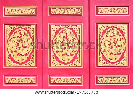Red wooden door with Chinese golden dragons