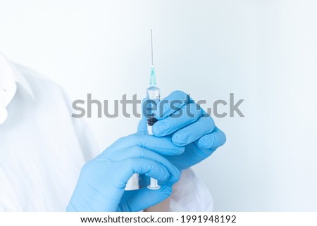 The doctor holds a syringe in his hands. Preparing for vaccination. Medical manipulation and treatment.