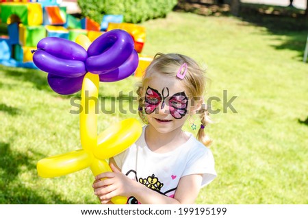 blond girl with face painting Royalty-Free Stock Photo #199195199