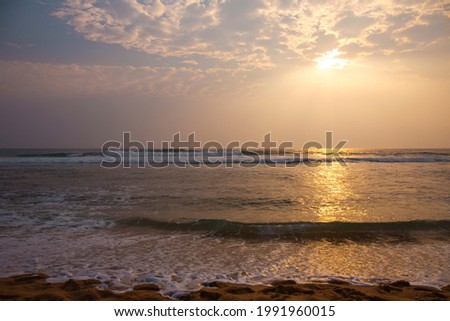 Beautiful pink sunset by the raging ocean, summer background