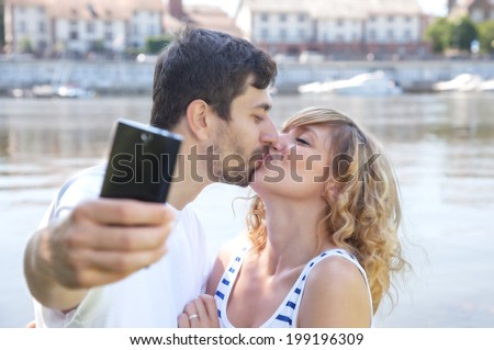 Kissing couple, making a selfie