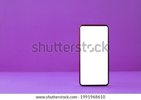 Blank screen smartphone on violet background.