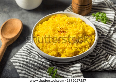 Homemade Healthy Saffron Rice in a Bowl Royalty-Free Stock Photo #1992027557